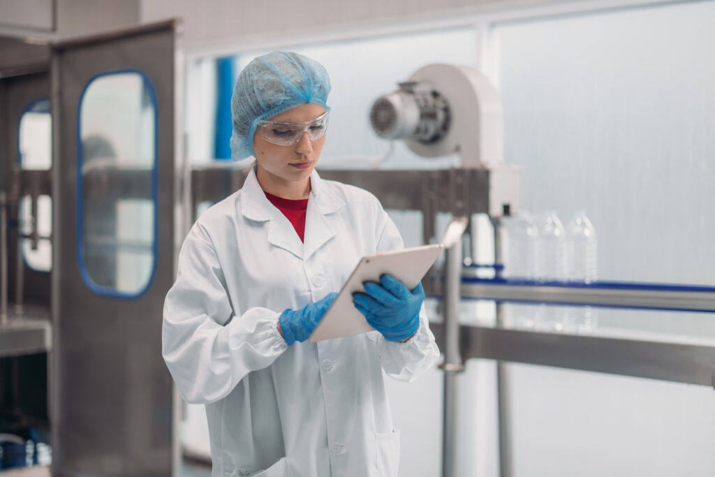 Supervisors check automated bottling for sequence accuracy, safety, reliability at water pipeline.